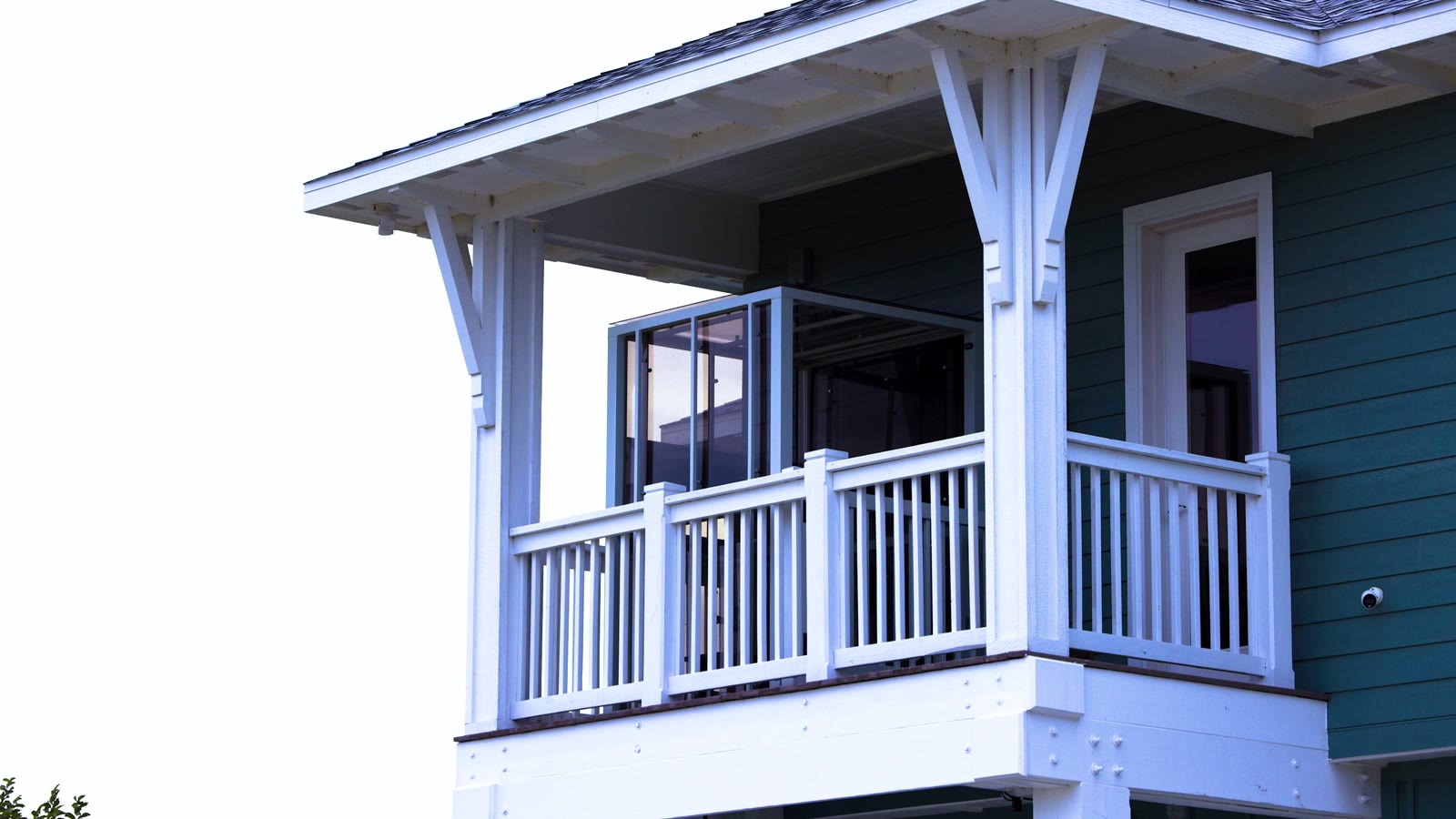 Wide view of the blue raised home and its exterior Traveler lift